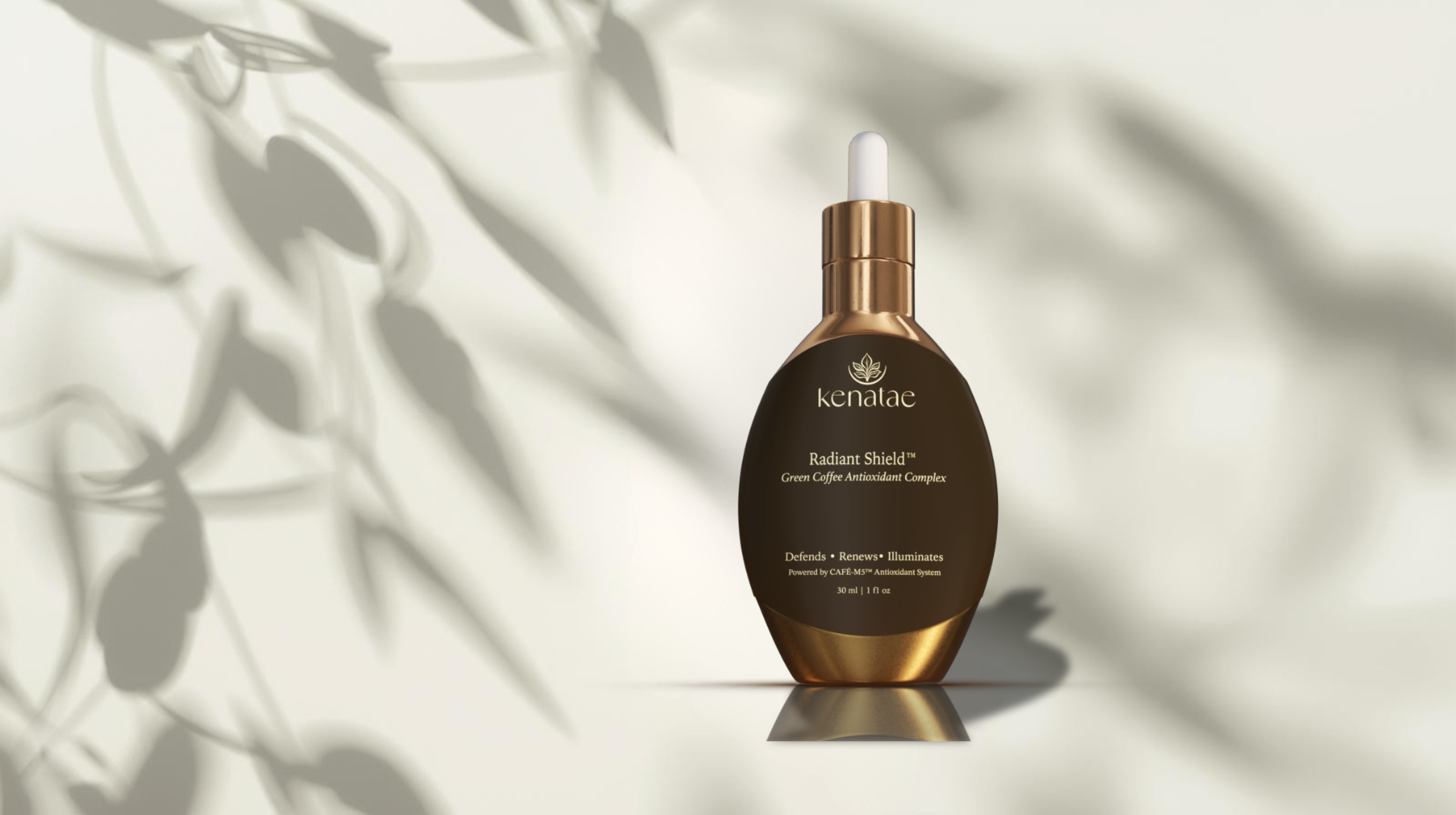 Kenatae's Radiant Shield antioxidant oil on a beige background with botanical leaves