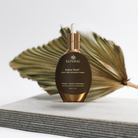 Kenalae Radiant Shield serum bottle on a light background with a dried leaf