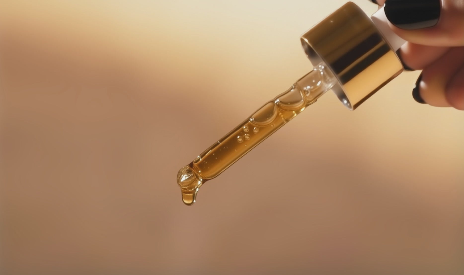 Kenatae's Radiant Shield serum being dispensed from the glass oil dropper on a beige background